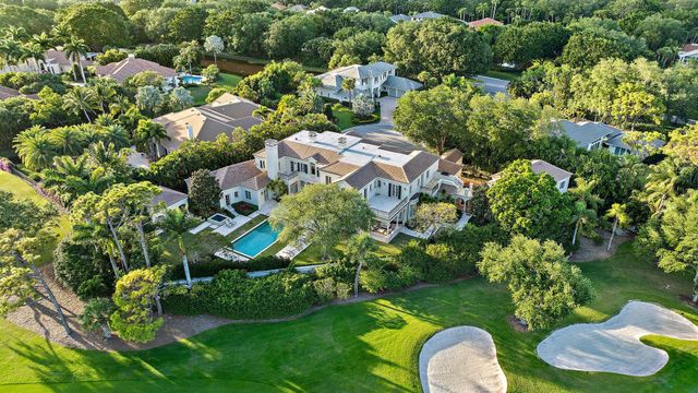 an aerial view of a house with yard swimming pool and outdoor seating
