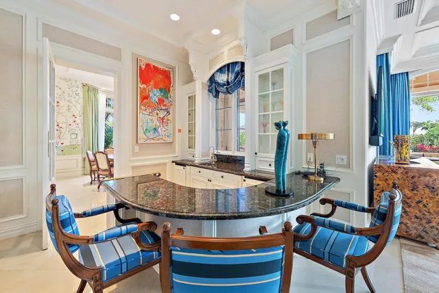 a kitchen with stainless steel appliances granite countertop a kitchen island a stove and a sink