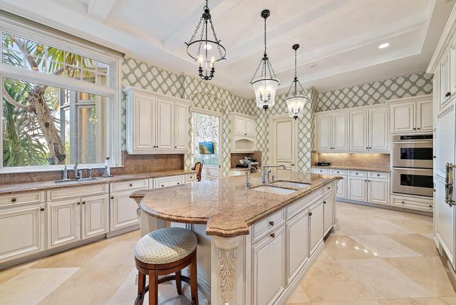 a kitchen with stainless steel appliances granite countertop a sink and dishwasher a oven with wooden cabinets