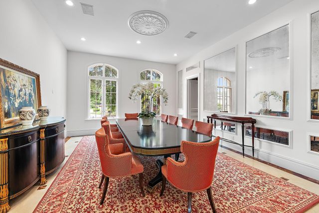 a view of a dining room with furniture and chandelier