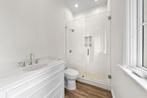 a view of a patio with couches chairs and wooden floor