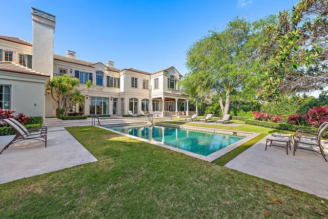 a bedroom with furniture and a large window