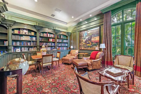 a bedroom with furniture and a large window