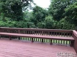 a view of a wooden deck and a yard