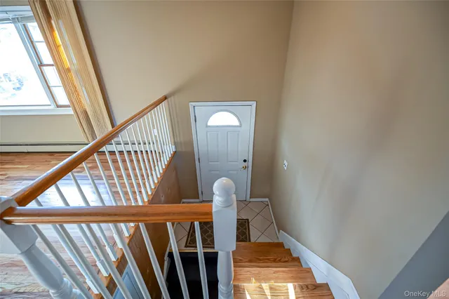 a view of staircase with railing and white walls
