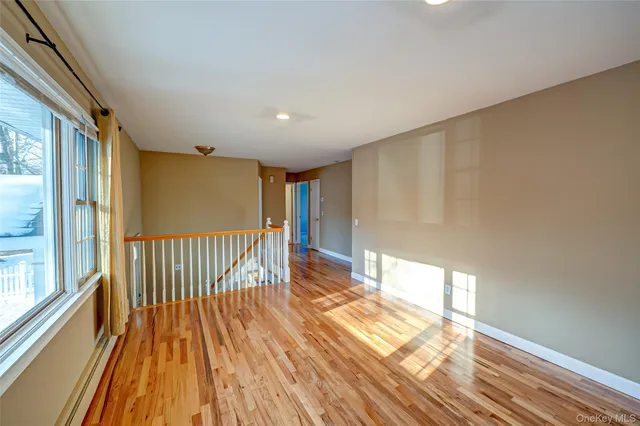 a view of wooden floor in a hall with an entryway