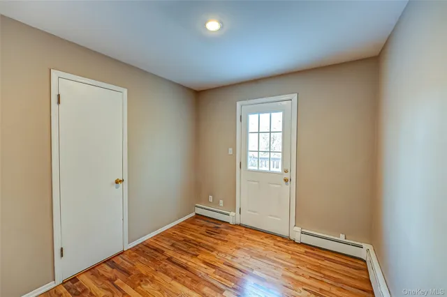 a view of a room with wooden floor and closet