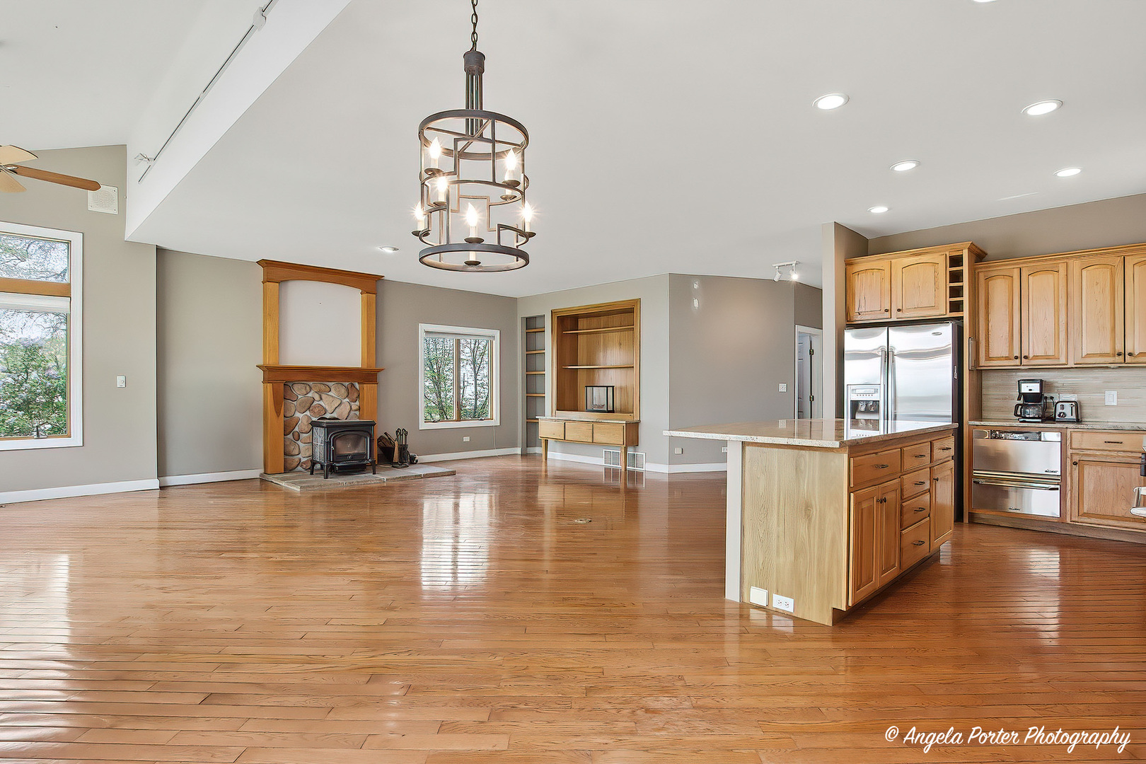 35166 Lake Shore Road Ingleside, IL 60041 - Photo 16 of 39 a view of a living room and kitchen with furniture wooden floor windows