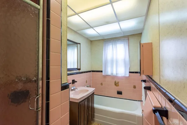 a bathroom with a bathtub and a sink