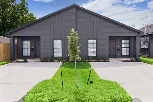 a house with a yard plants in front of it