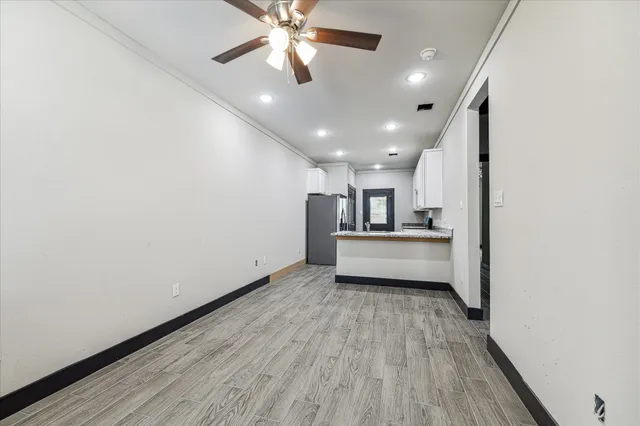 a view of a kitchen with a dishwasher and wooden floor