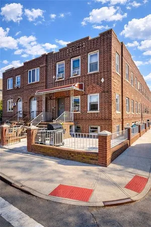 a front view of a residential apartment building with a garage