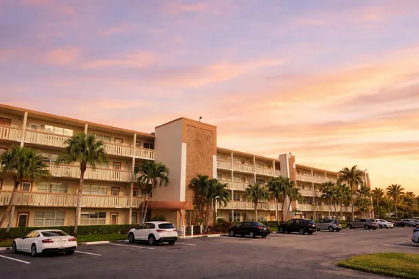 a living room with furniture a flat screen tv and a potted plant
