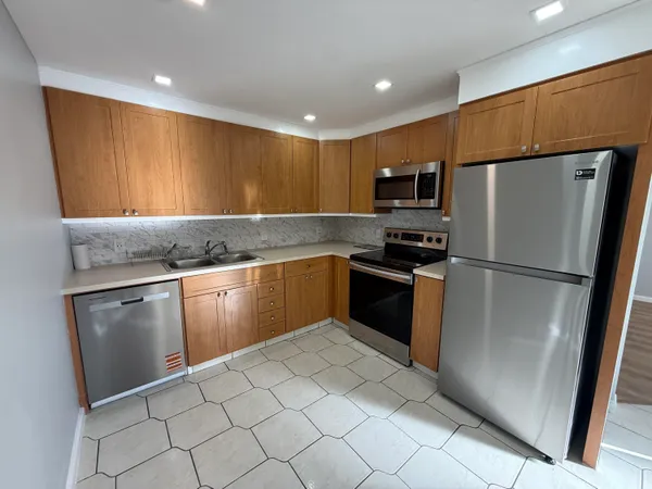 a living room with furniture a flat screen tv and a potted plant