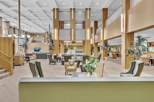 a spacious bathroom with a toilet sink and a mirror