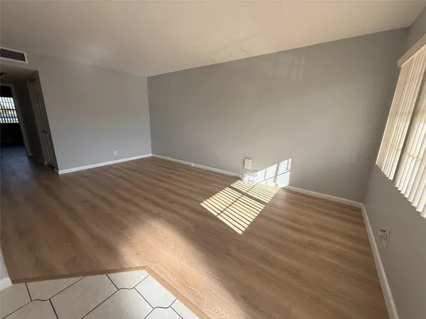 an aerial view of a residential houses with outdoor space and seating area