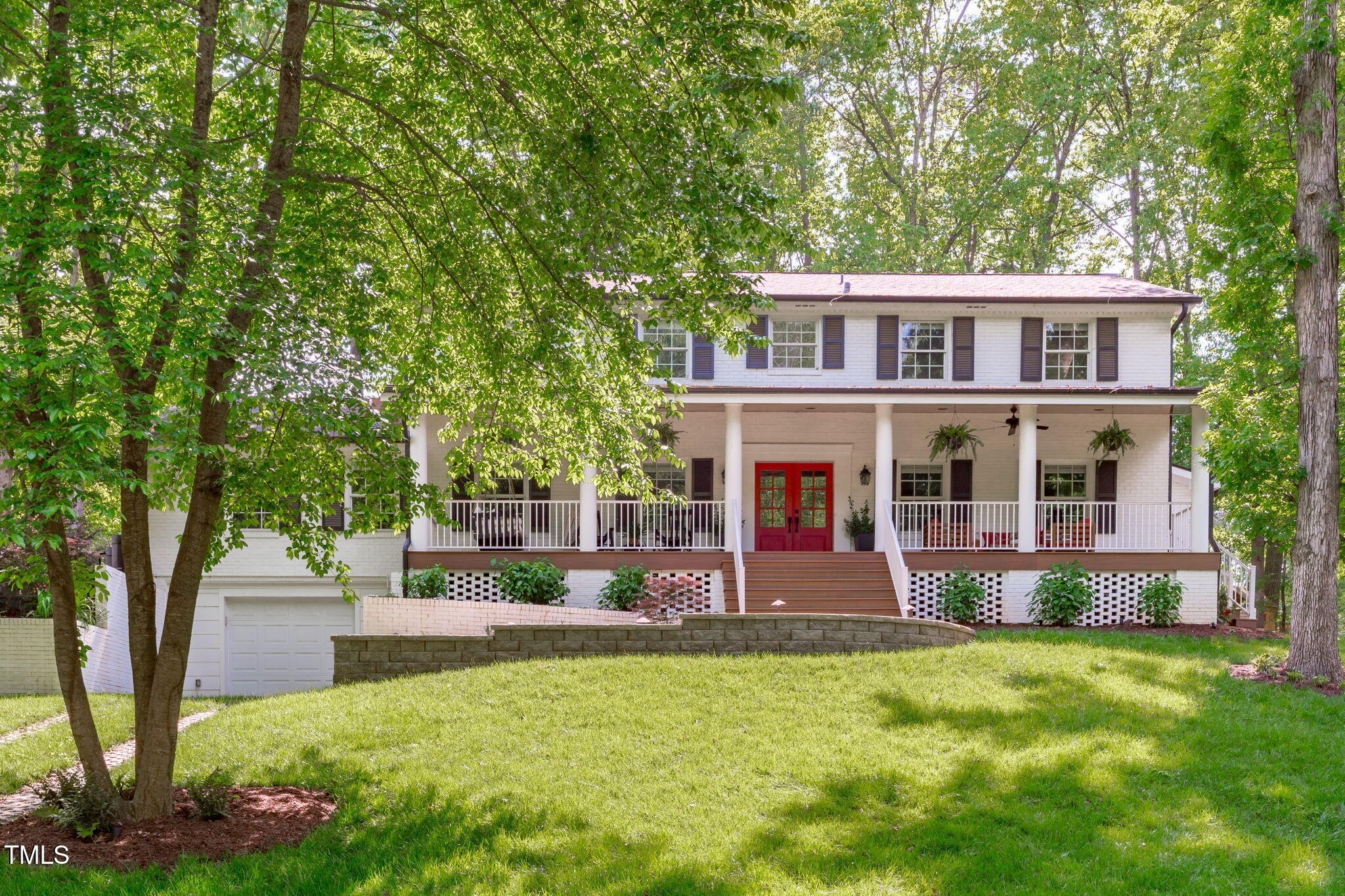 a front view of a house with a yard table and chairs