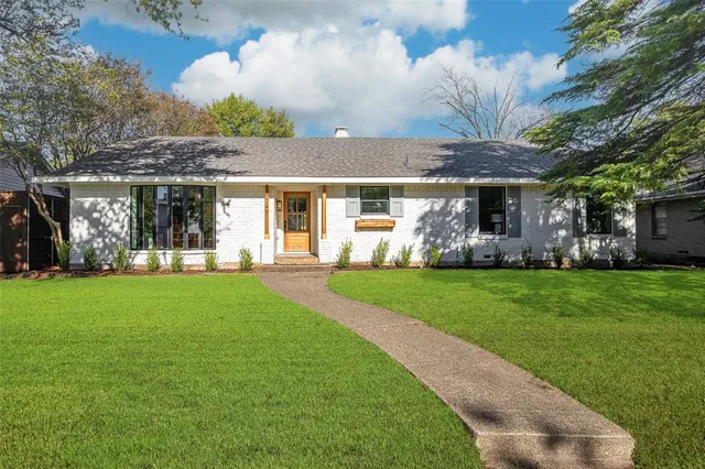 a front view of house with yard and outdoor seating