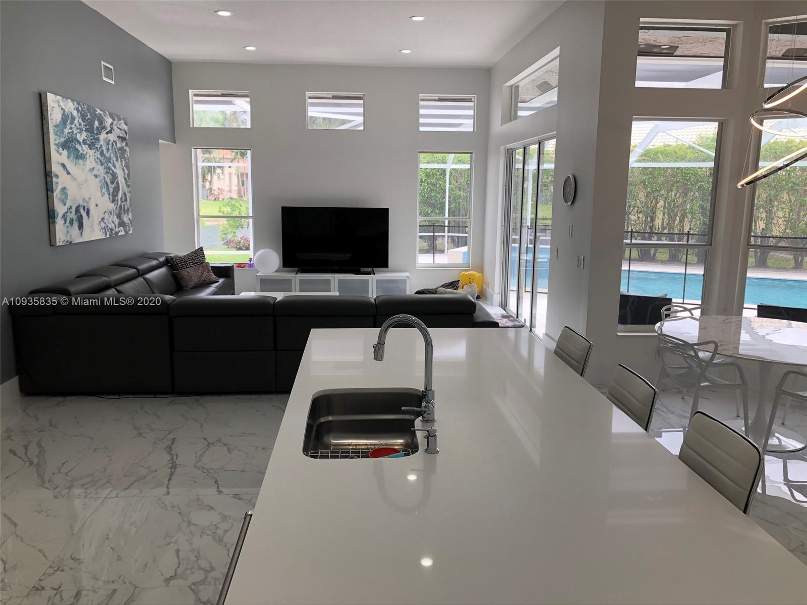 Boca Isles Boca Raton, FL 33498 - Photo 3 of 17 a living room with furniture and a flat screen tv