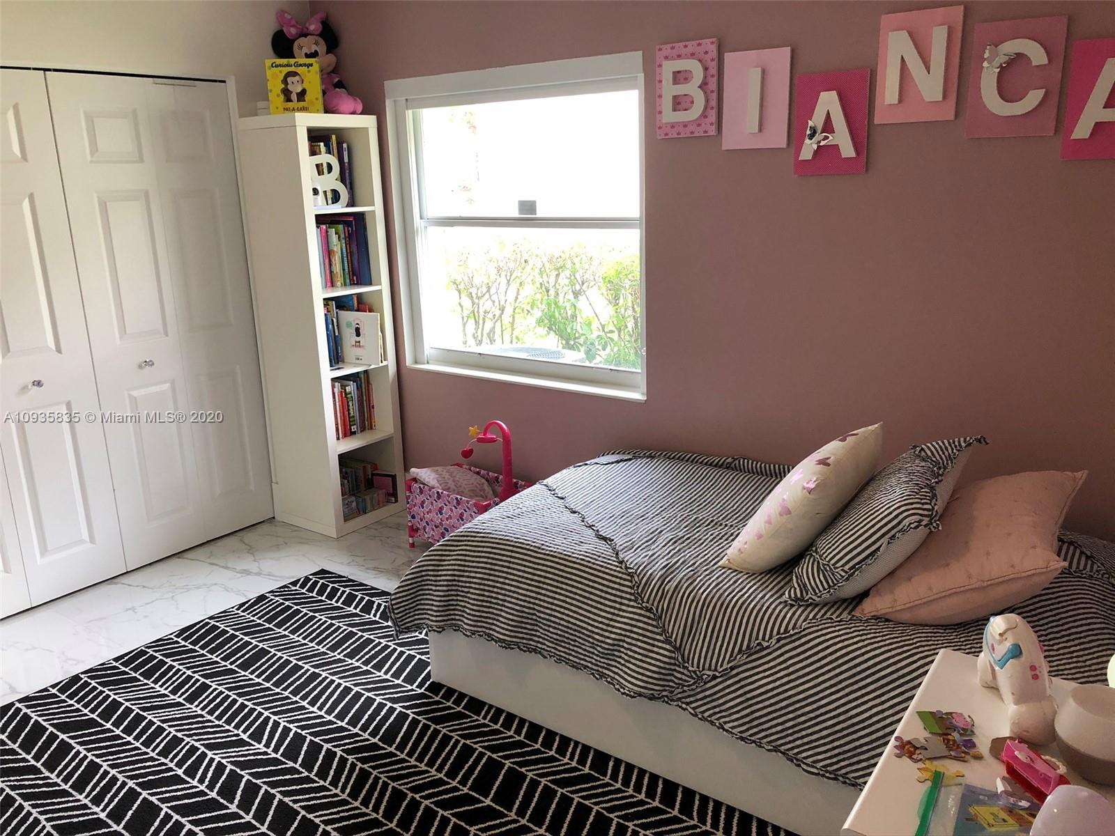 Boca Isles Boca Raton, FL 33498 - Photo 7 of 17 a bedroom with a bed and a window