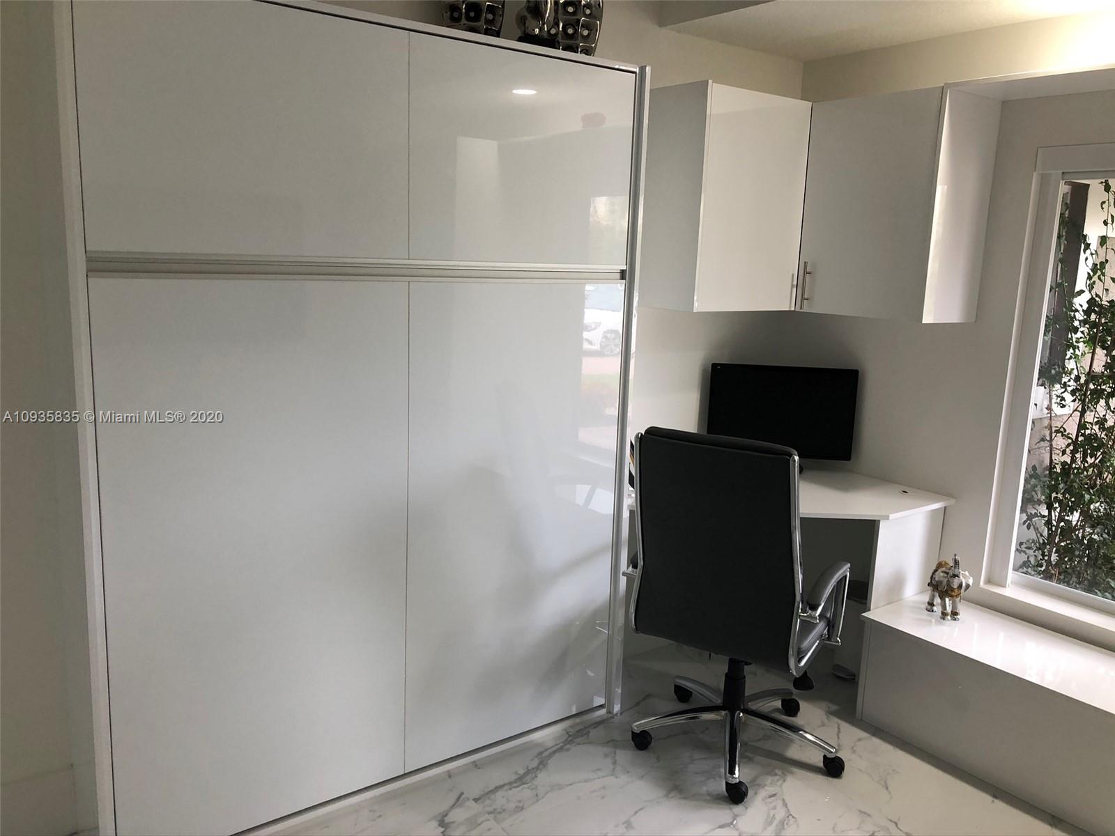 Boca Isles Boca Raton, FL 33498 - Photo 10 of 17 a view of a workspace with furniture and a window