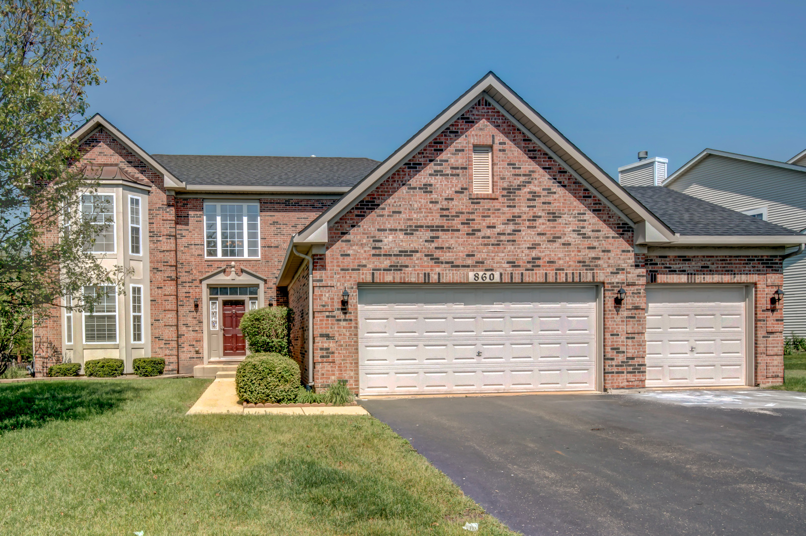 860 Spring Creek Circle Naperville, IL 60565 - Photo 2 of 26 a front view of a house with a yard and garage