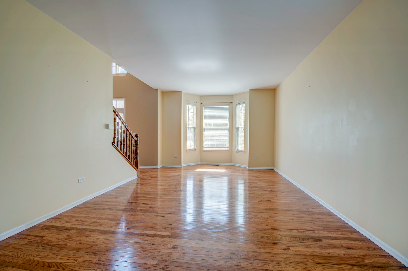 860 Spring Creek Circle Naperville, IL 60565 - Photo 5 of 26 a view of an empty room with wooden floor and a window