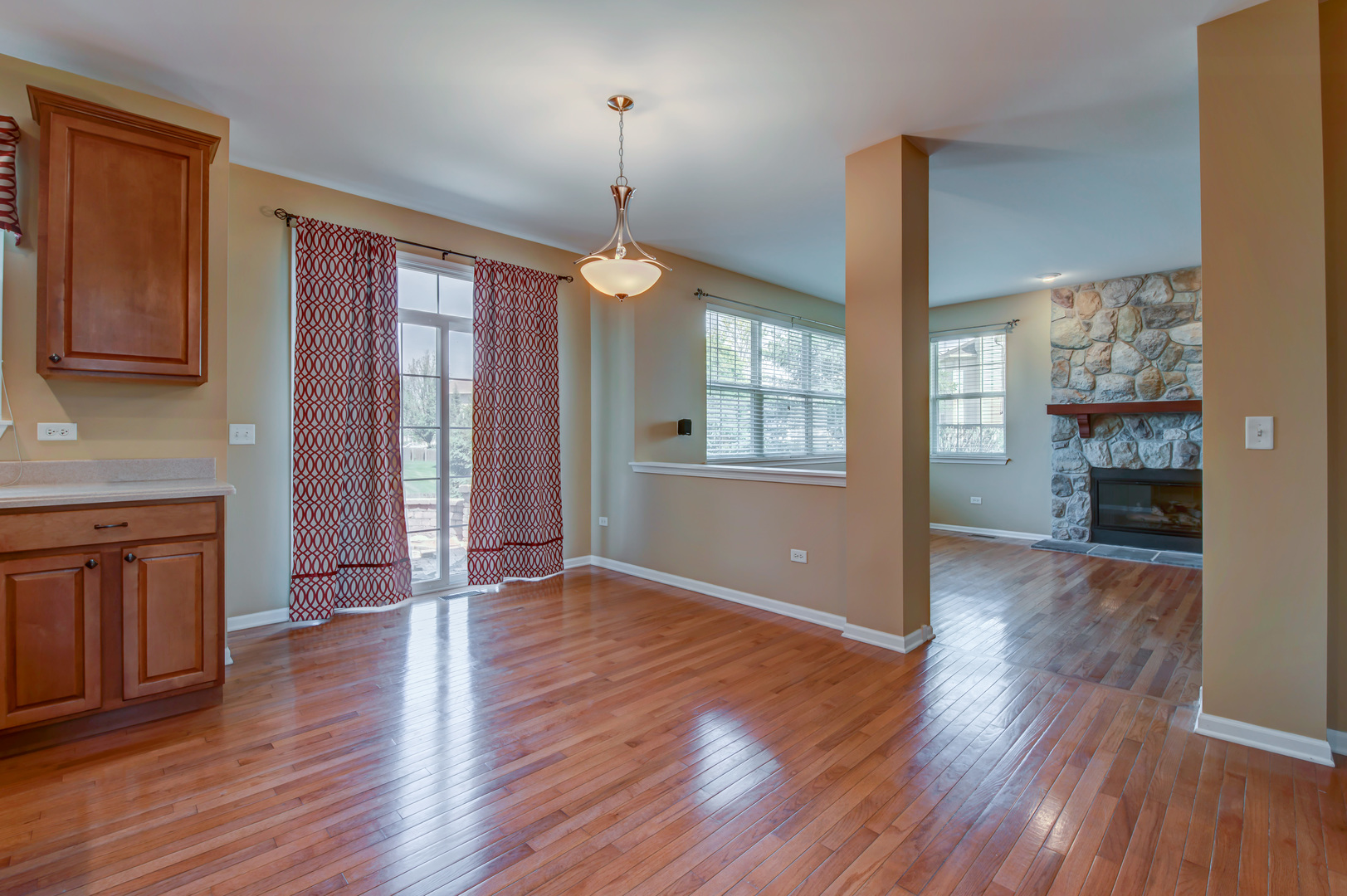 860 Spring Creek Circle Naperville, IL 60565 - Photo 9 of 26 a view of an empty room with window and wooden floor