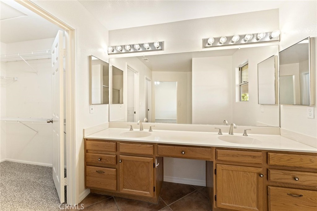 1886 Tamarack Lane Hemet, CA 92545 - Photo 19 of 40 a bathroom with a double vanity sink and mirror