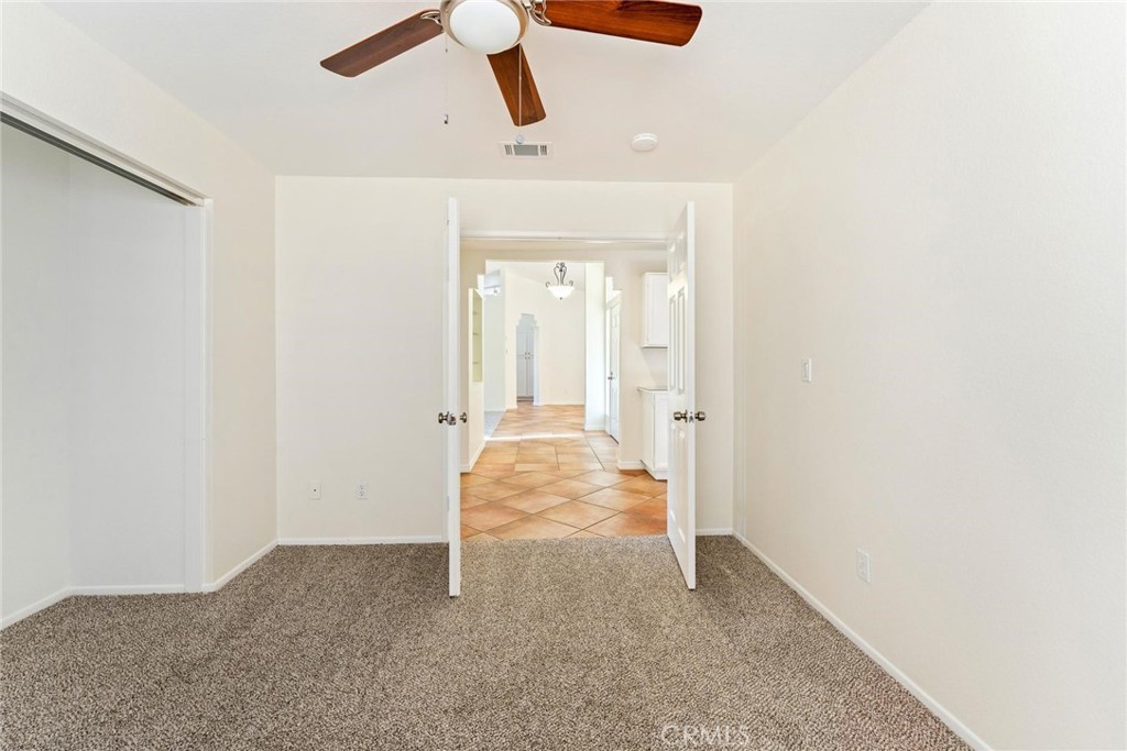1886 Tamarack Lane Hemet, CA 92545 - Photo 22 of 40 an empty room with ceiling fan and window