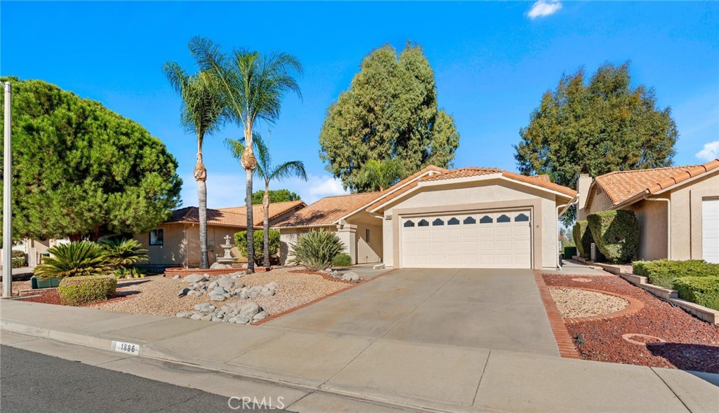1886 Tamarack Lane Hemet, CA 92545 - Photo 4 of 40 a view of a house with a yard and potted plants