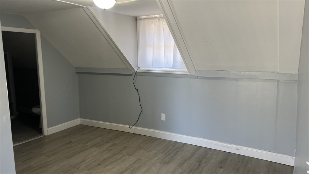 12.5 Benefit Street, Unit 2 Worcester, MA 01610 - Photo 4 of 10 a view of an empty room with wooden floor and a window