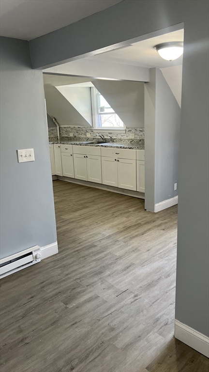 12.5 Benefit Street, Unit 2 Worcester, MA 01610 - Photo 9 of 10 a view of an empty room and wooden floor