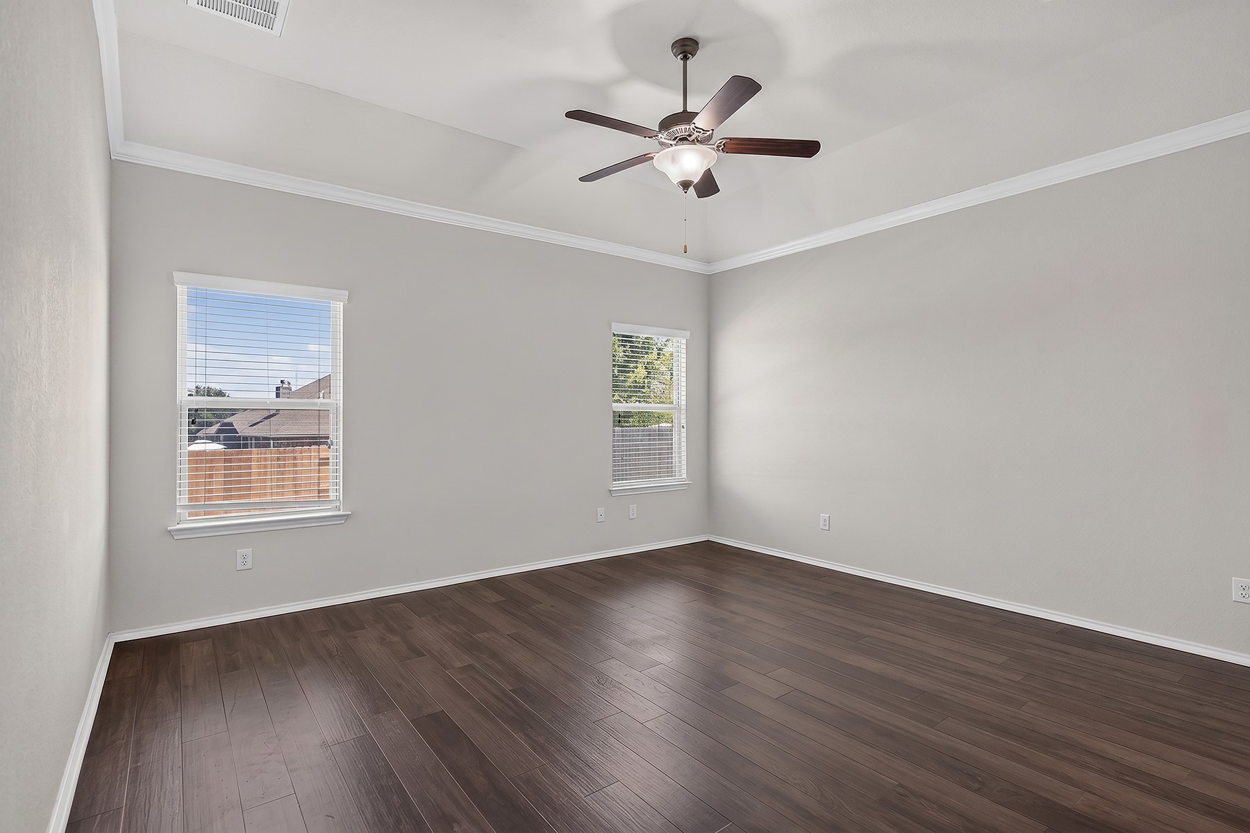 4601 Chestnut Meadows Bend Georgetown, TX 78626 - Photo 15 of 35 Rich hardwood flooring complements the crisp crown molding in this naturally illuminated bedroom.