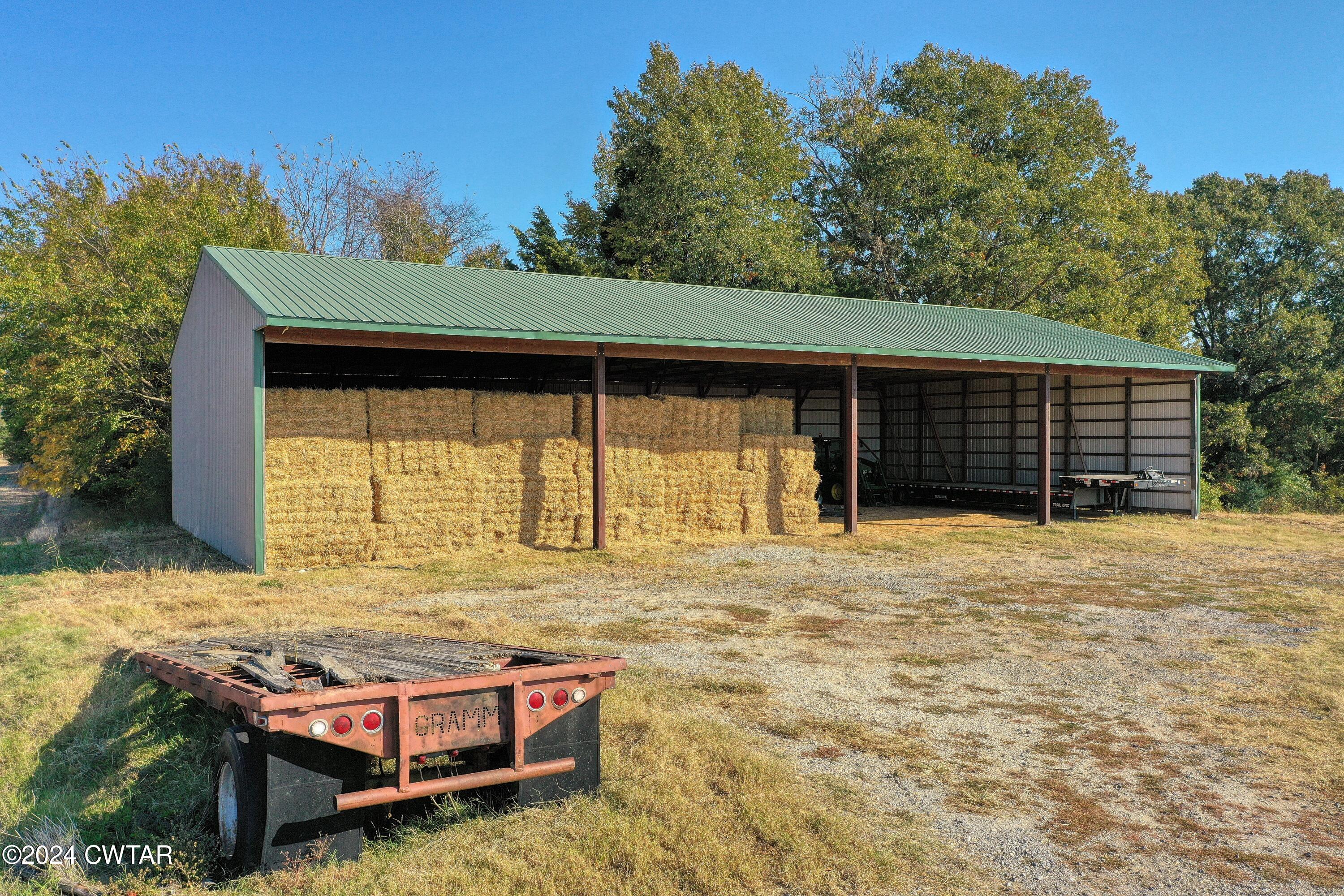 28 Peavine Road Bradford, TN 38316 - Photo 5 of 16 a backyard of a house with barbeque oven table and chairs