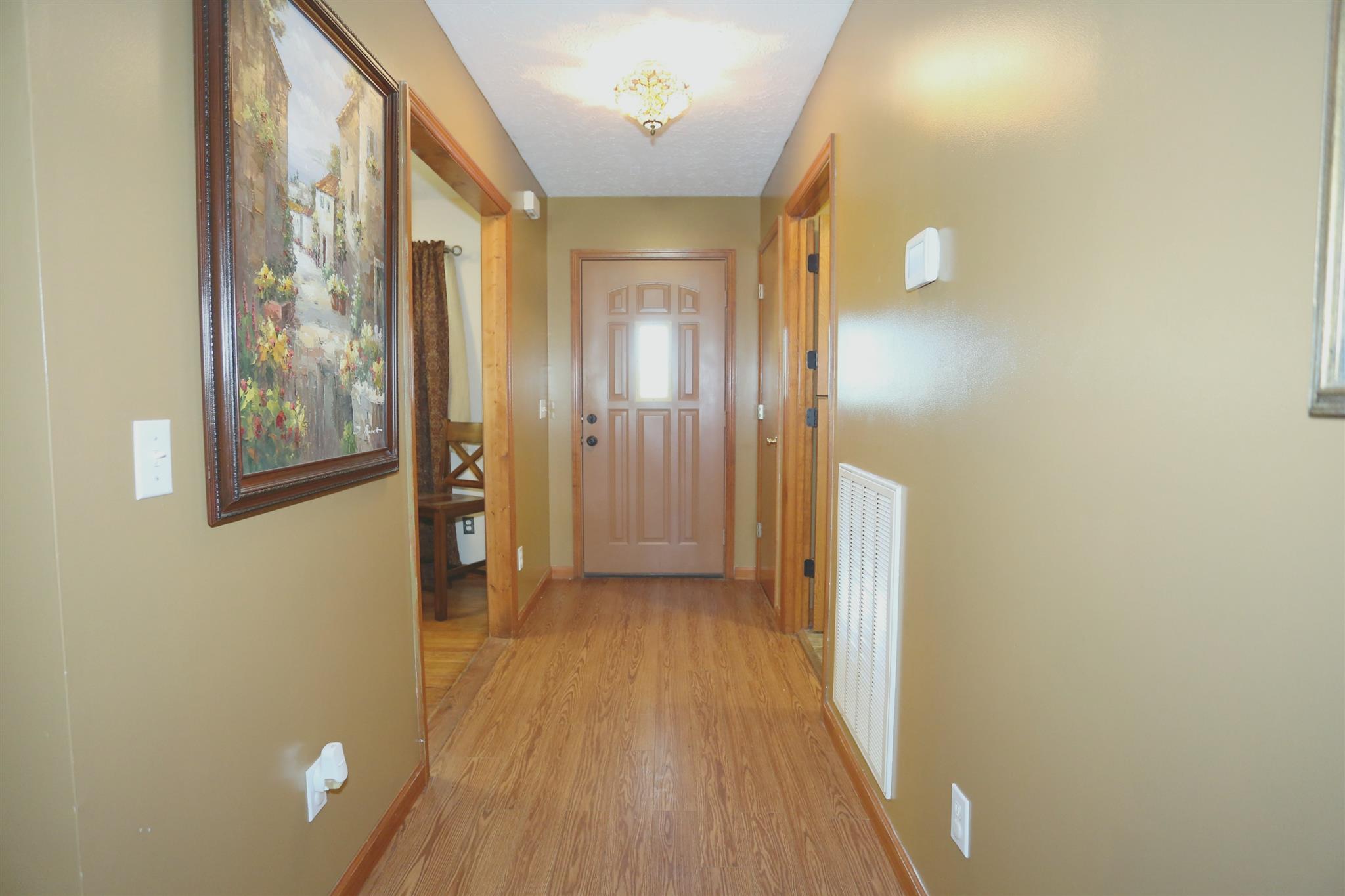 137 Urban Farms Road Manchester, TN 37355 - Photo 5 of 21 a view of a hallway with wooden floor and a bathroom