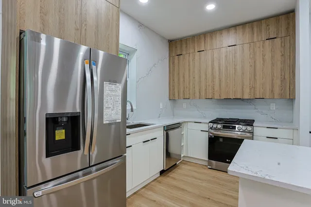 a kitchen with a refrigerator sink and stove