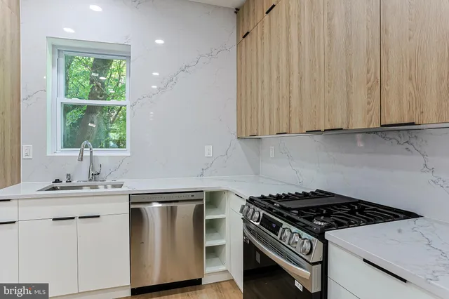 a kitchen with a sink stove and cabinets
