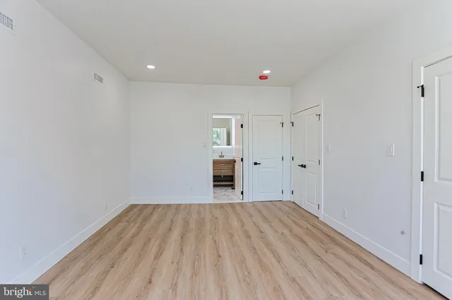 a view of a room with wooden floor and window