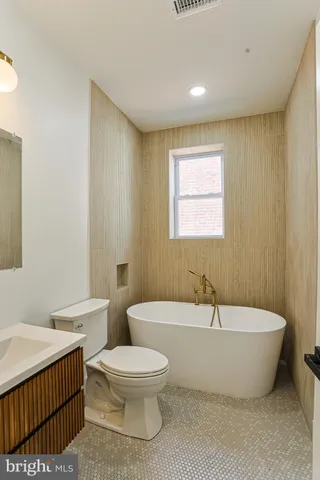 a spacious bathroom with a bathtub and toilet