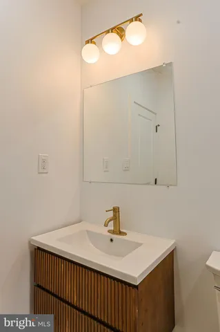 a bathroom with a sink vanity and a mirror