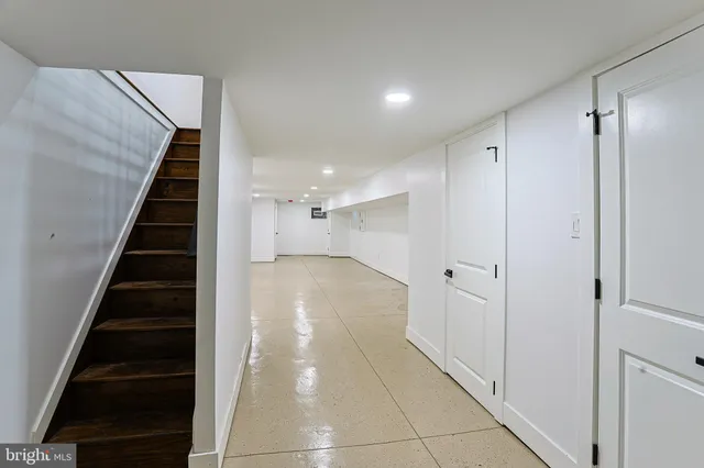 a view of a hallway with wooden floor and entryway
