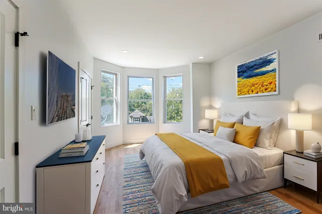 a bedroom with bed and wooden floor