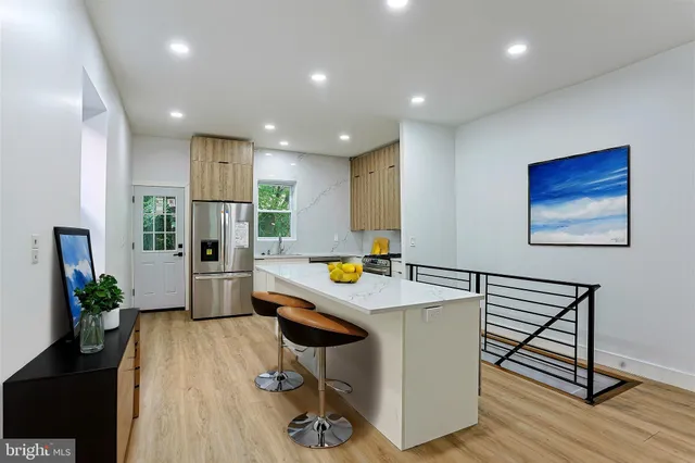 a kitchen that has a table and chairs in it