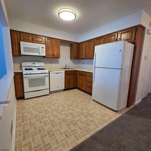 a kitchen with a refrigerator sink and stove