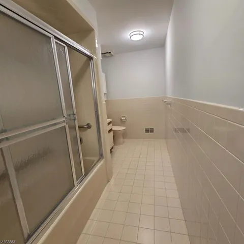a bathroom with a toilet a sink and a mirror
