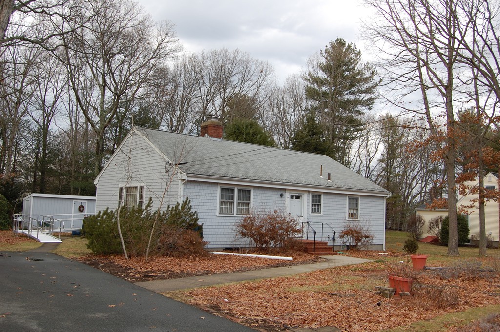 77 Old Post Road Walpole, MA 02032 - Photo 1 of 21 a front view of a house with a yard and garage