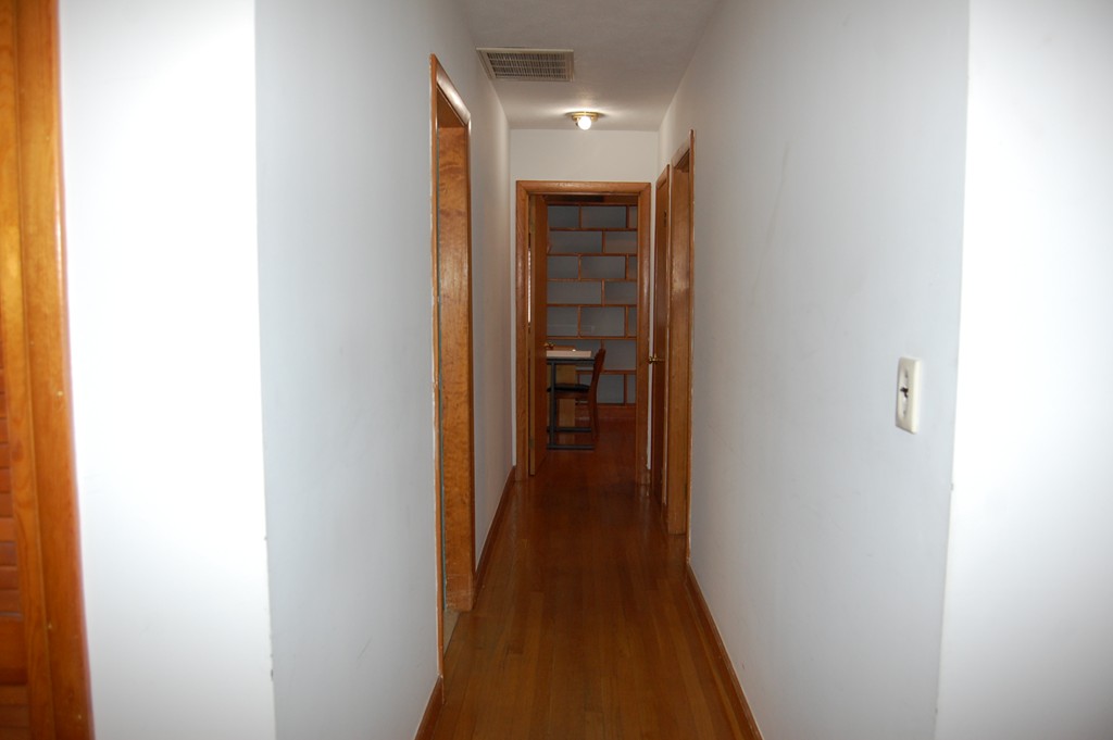 77 Old Post Road Walpole, MA 02032 - Photo 10 of 21 a view of a hallway with wooden floor and staircase
