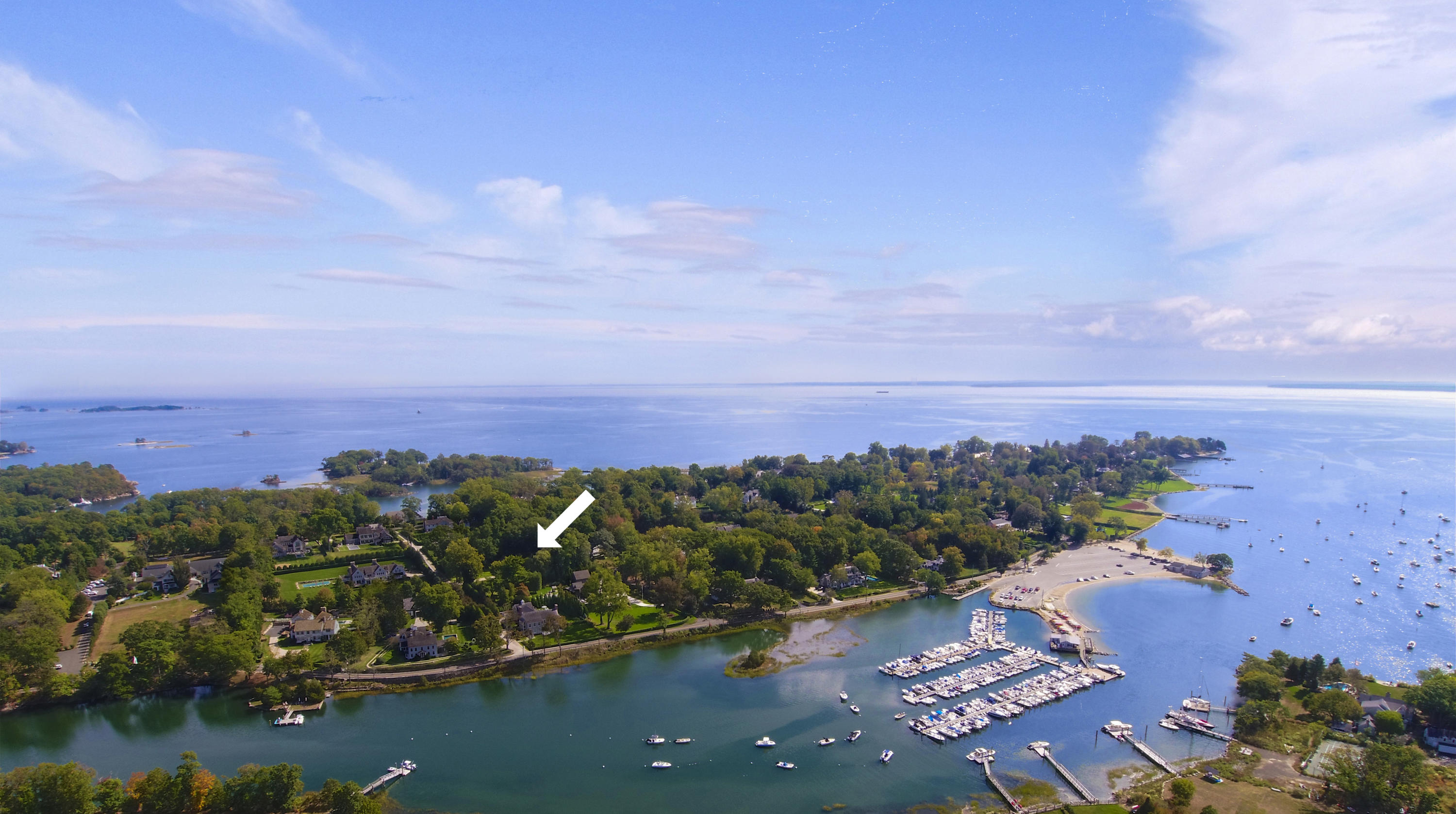 96 Long Neck Point Road Darien, CT 06820 - Photo 6 of 6 an aerial view of a city with lots of residential buildings ocean and mountain view in back