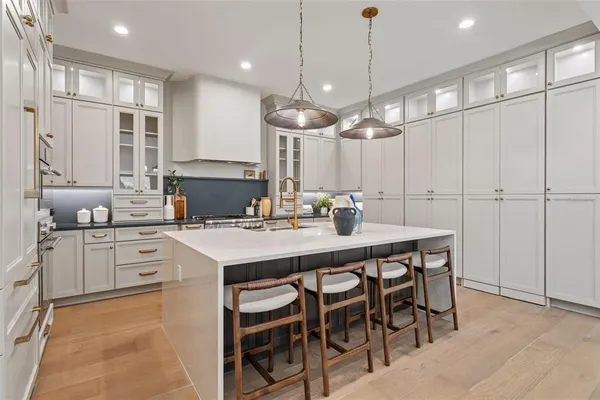 a kitchen with a table chairs sink and cabinets